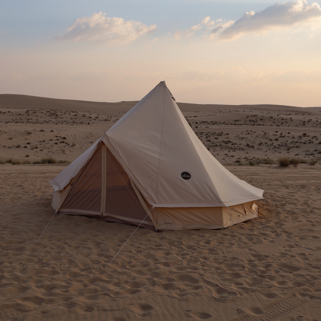 The Bedouin bell tent on open desert ground under an evening sky