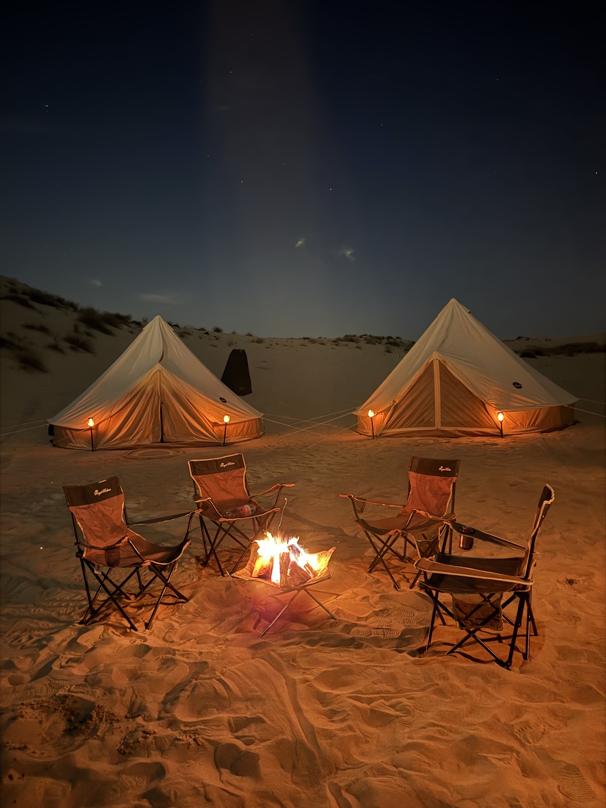 Campfire glowing at a Nomadic camp at night