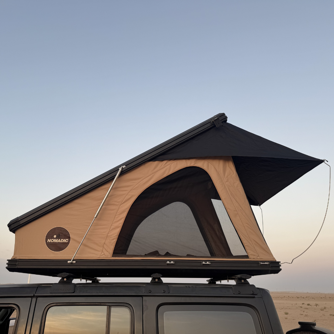 Close view of the Nomad rooftop tent open, tan canvas and mesh window