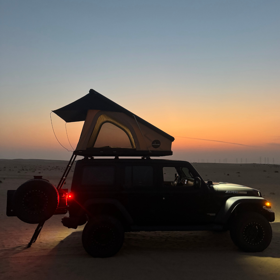 Side view of the Nomad rooftop tent on a 4x4 at desert dusk