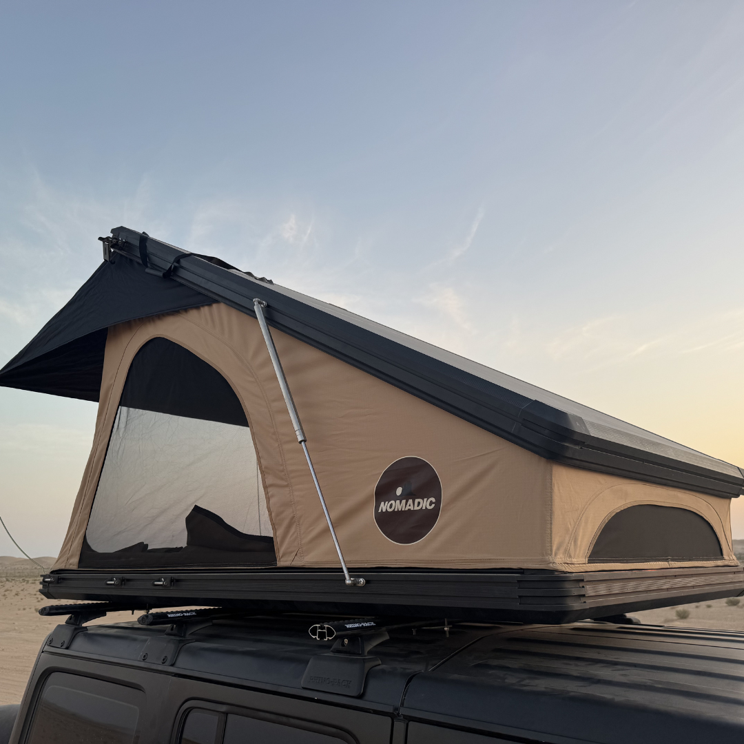 Front view of the Nomad rooftop tent open, mesh windows and beige canvas
