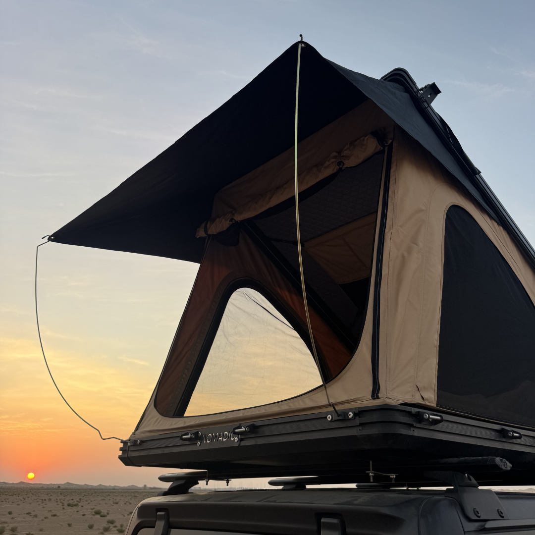 The Nomad rooftop tent from behind at sunset, roof strut and canvas visible