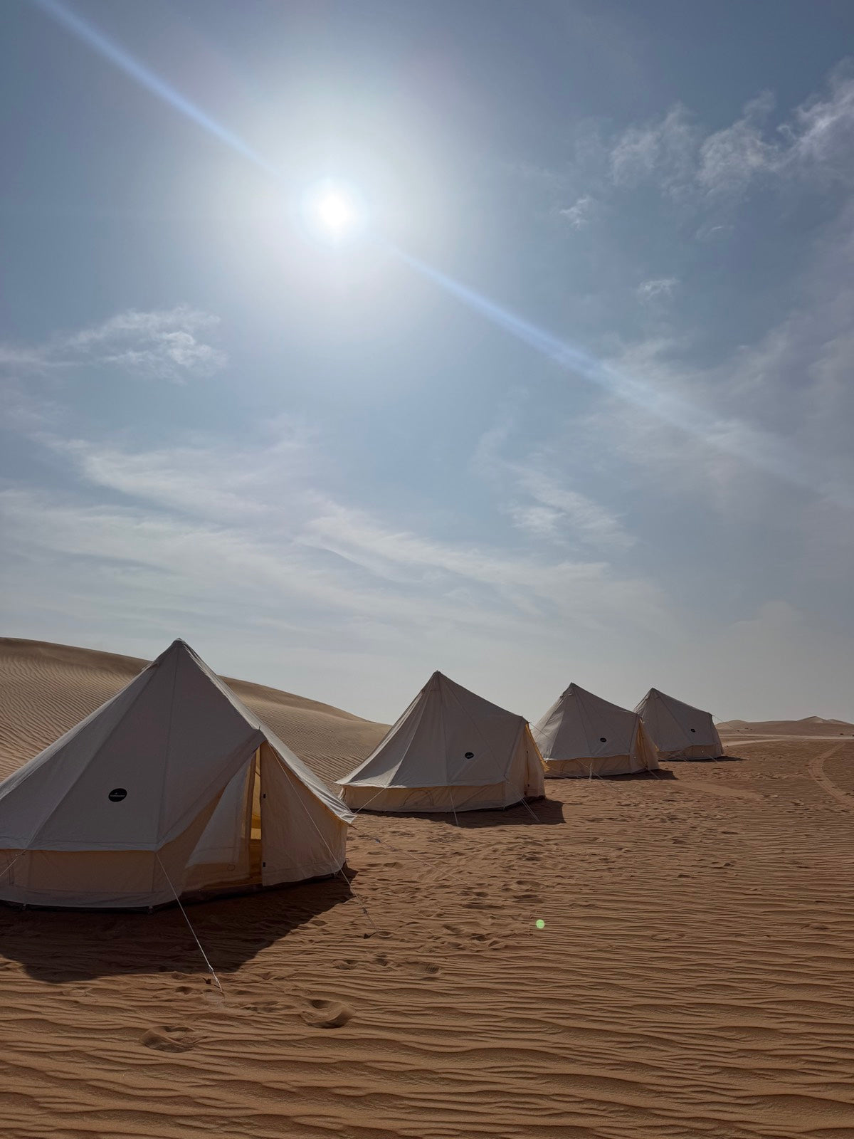 Glamping bell tents in a row on desert dunes