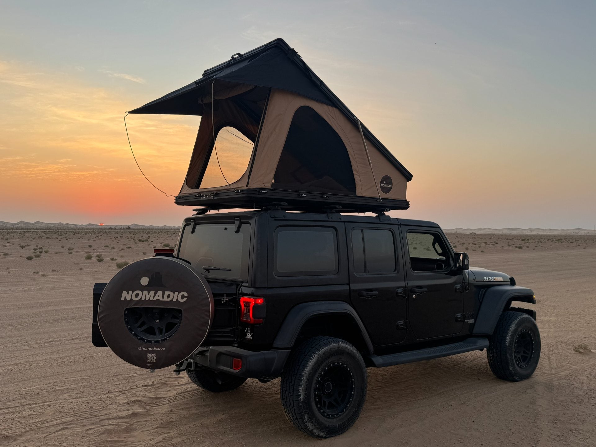 Rooftop tent on a Jeep at sunset