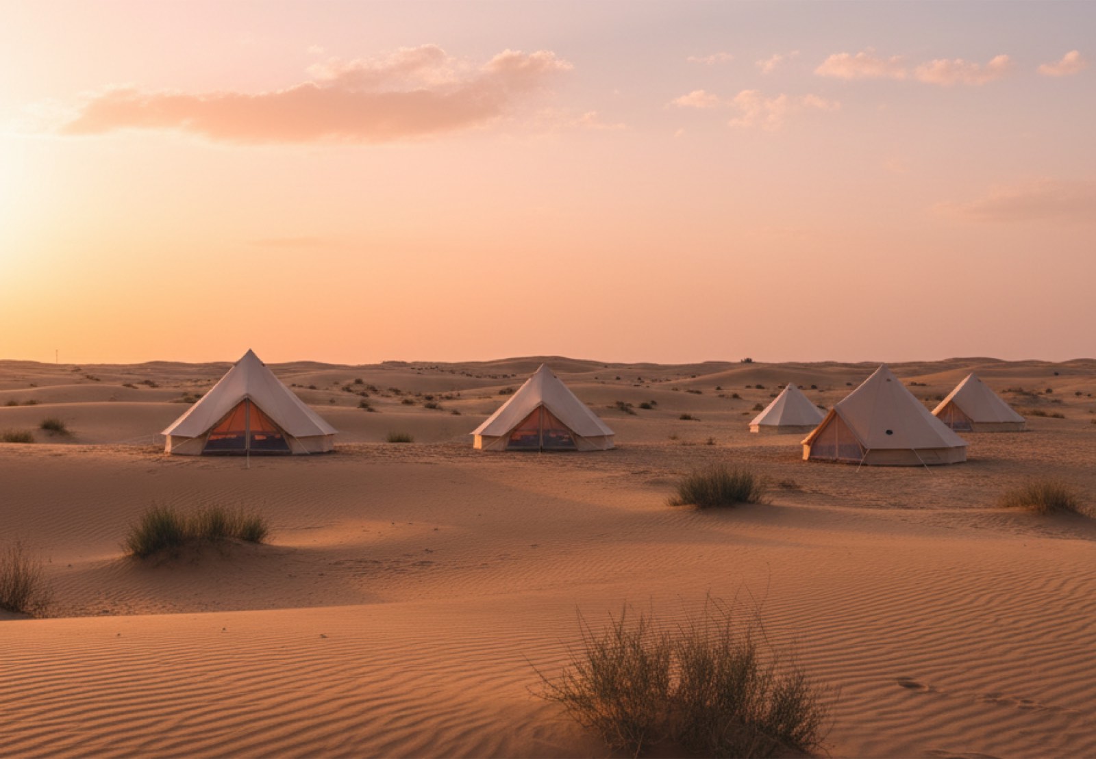 Tents pitched among desert dunes